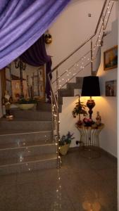 a stairway with a blue curtain and lights at Villa Casafina Serviced Apartments in Mangalia