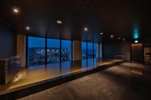 a large room with a view of a city at AMANEK Beppu YULAｰRE in Beppu