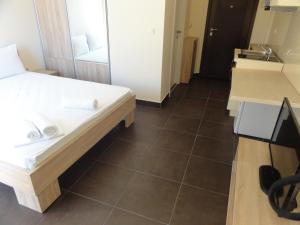 a small room with a bed and a sink at The Old Town Viewpoint Apartments in Budva +61 photos