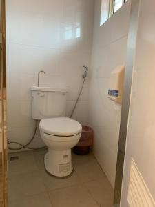 a bathroom with a white toilet in a room at Jia's Homestay in Lugu Lake