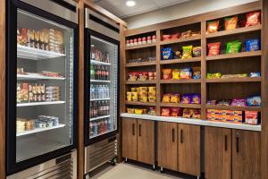 a kitchen with a refrigerator and lots of food at La Quinta by Wyndham Port Arthur in Port Arthur