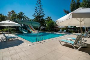 a pool with a slide and some chairs and umbrellas at Iz Flower Side Beach Hotel in Side