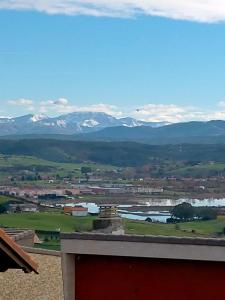 a view of a town with mountains in the background at La Casa del Limonero in Suances