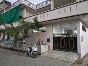 a scooter parked in front of a building at Videep house in Kānpur