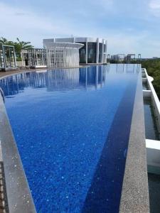 a large pool of blue water in front of a building at Nice stay in heart of Kota Bharu@Troika,free Wifi. in Kota Bharu