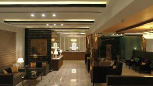 a lobby with couches and chairs in a building at Swat Palace Hotel By Northin in Mām Derai