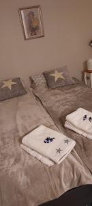 a bed with two towels and stars on it at Polaris Homes Huippu in Syöte