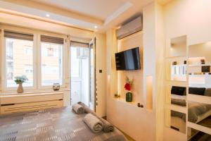 a small room with a bed and a window at Arizona in Novi Sad