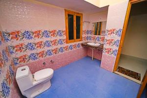 a bathroom with a toilet and a sink at FabHotel Corbett Green View Garden and Stay in Rāmnagar