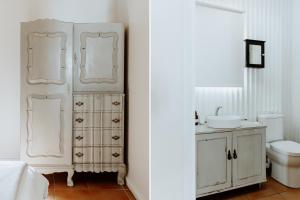 a white bathroom with a sink and a toilet at Joyful in Paternoster +12 photos