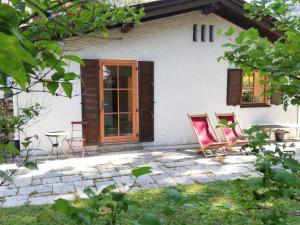 two chairs on a patio in front of a house at Ferienwohnung Bergahorn in Oberaudorf