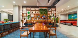 a restaurant with a wooden table and chairs at Sundia Exclusive By Liberty Fethiye Adults Only in Fethiye