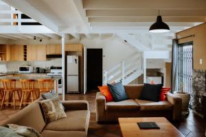 a living room with two couches and a kitchen at Craylord in Paternoster