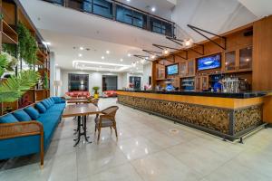 a bar in a restaurant with a blue couch at Sundia Exclusive By Liberty Fethiye Adults Only in Fethiye