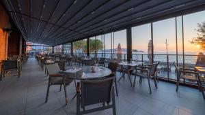 a restaurant with tables and chairs and a view of the water at Sundia Exclusive By Liberty Fethiye Adults Only in Fethiye