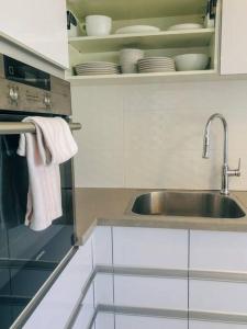 a kitchen with a sink and a dish towel at Royal Aparatment on the Sea , Blvd Nitza 34 in Netanya