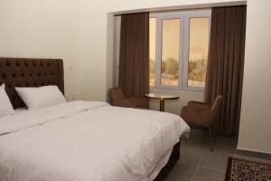 Tempat tidur dalam kamar di فندق زيلامسي