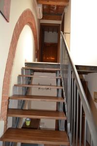 a staircase leading up to a room with a bunch of stairs at Antico Borgo Casalappi in Campiglia Marittima