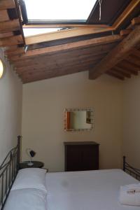 a bedroom with a bed and a window at Antico Borgo Casalappi in Campiglia Marittima