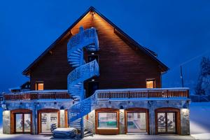 a building with a statue in front of it at Hotel Restaurant Mont Champ du Feu in Belmont