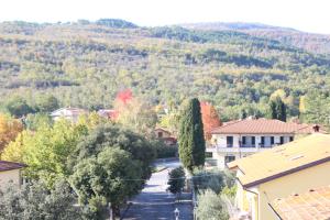 a street in a small town with trees and mountains at Boutique Hotel Fox's Inn in San Giustino Valdarno