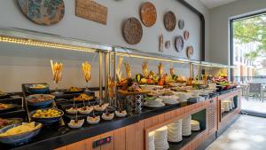 a buffet line with plates and bowls of food at Sundia Exclusive By Liberty Fethiye Adults Only in Fethiye
