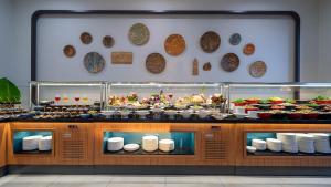 a buffet line with plates and food on display at Sundia Exclusive By Liberty Fethiye Adults Only in Fethiye