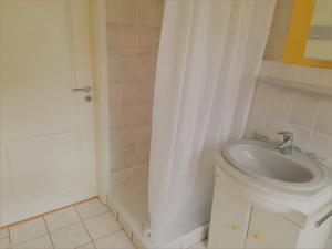 a bathroom with a toilet and a sink and a shower at Ferienwohnung Kahlenberg in Thale