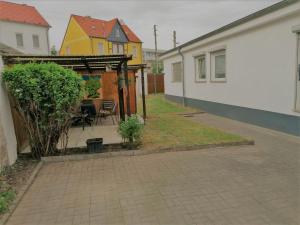 a backyard with a table and a gazebo at Ferienwohnung Kahlenberg in Thale