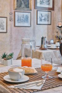 a table with a plate of food and a pitcher of orange juice at B&B da Miriam in Castelnuovo del Garda