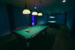 a pool table in a dark room with two tables at Castello Mare All Inclusive Resort in Batumi
