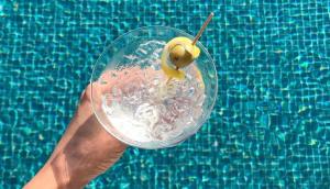 a person holding a drink with a lemon on top of a swimming pool at Sundia Exclusive By Liberty Fethiye Adults Only in Fethiye