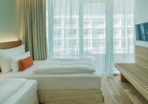 Voodi või voodid majutusasutuse Falkensteiner Hotel & Spa Jesolo toas