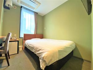Łóżko lub łóżka w pokoju w obiekcie Hotel Tetora