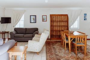 a living room with a couch and a table at In Betwix in Paternoster