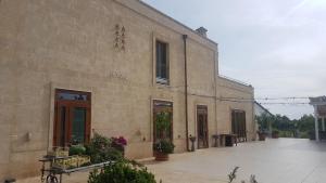 a stone building with a patio in front of it at Il Praedio Della Reale in Ginosa