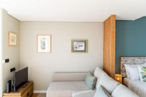 A bed or beds in a room at Rooftop Funchal I by Madeira Best Apartments