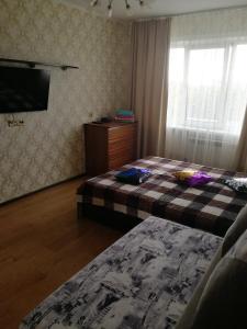 En eller flere senge i et værelse på "СКомфортом" однокомнатная квартира на Проспекте Мира 375