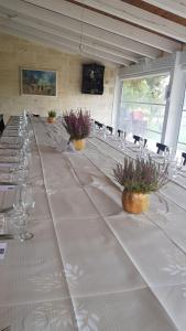 a long table with wine glasses and flowers on it at Il Praedio Della Reale in Ginosa