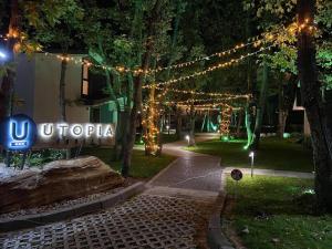 a lit up sign in a park with lights at Utopia Forest in Burgas