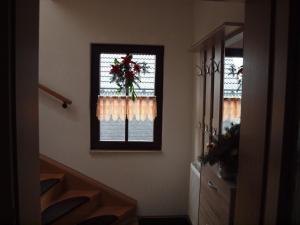 a hallway with two windows and a staircase with areath at Attraktive FeWo in Rosenthal am Rennsteig in Neundorf