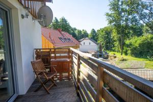 a balcony with two chairs and a table on it at Hirtenhaus 28b Erdgeschoss in Chorin