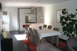una cucina e una sala da pranzo con tavolo e sedie di Holiday Home and Office Domisi'l a Wachtebeke