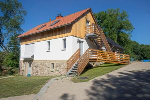 a house with a staircase leading up to it at Hirtenhaus 28b Obergeschoss in Chorin