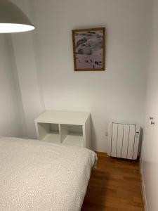 En eller flere senge i et værelse på Apartamento Plaza Pradollano 1