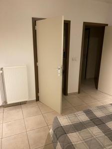a room with two doors and a tiled floor at 10mins from Brussels Airport 2 rooms living room and Patio in Zaventem