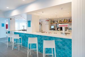 a bar in a restaurant with a blue counter top at BLUESEA Piscis - Adults Only in Port d'Alcudia
