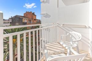 a white rocking chair on a balcony with a view at BLUESEA Piscis - Adults Only in Port d'Alcudia