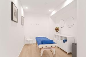 a white room with a bed and a table at BLUESEA Piscis - Adults Only in Port d'Alcudia