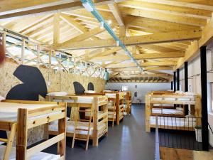 a dining room with wooden tables and benches at Santa Brigida - Real 1 in Hontanas